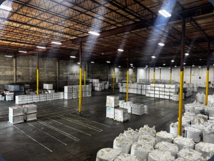 Warehouse interior with marked floor lanes and inventory